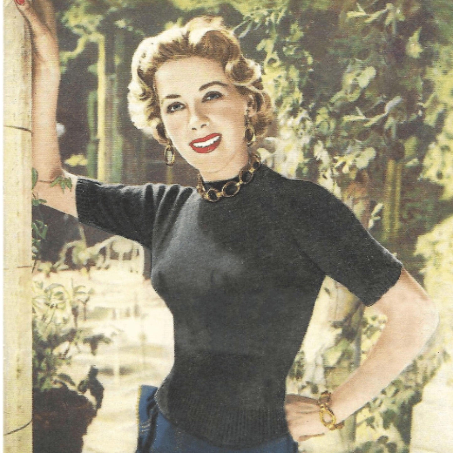 A black and white image of a woman from the 1940s, smiling and posing in a garden, wearing a vintage lace jumper and cardigan.