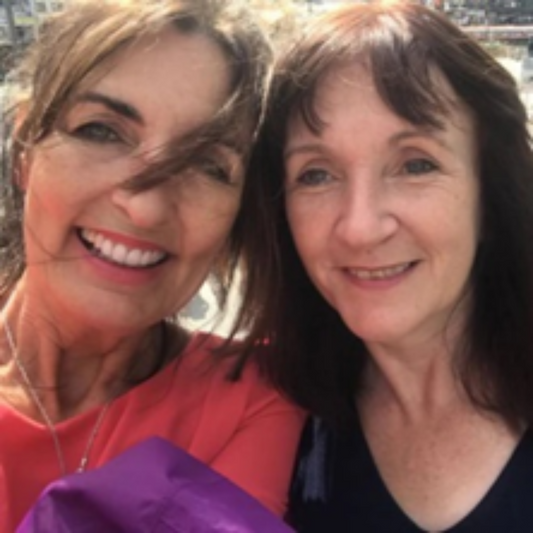 Dawn and Gill who are co owners of Vintage Sewing Pattern Company.  dawm has brown hair and wearing a pink top and Gill hs dark brown hair wearing a black top.