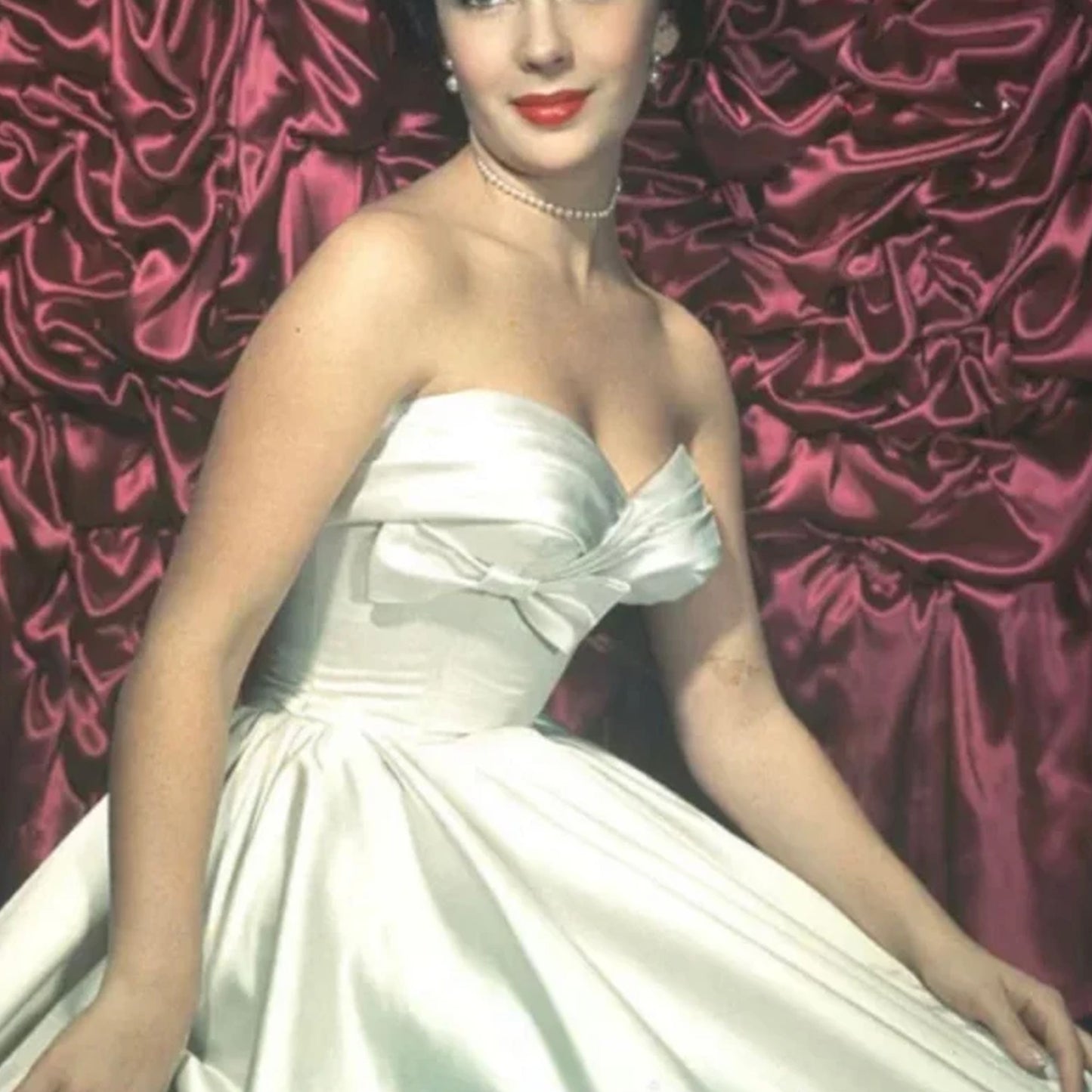 Elizabeth Taylor wearing a strapless ballgown
