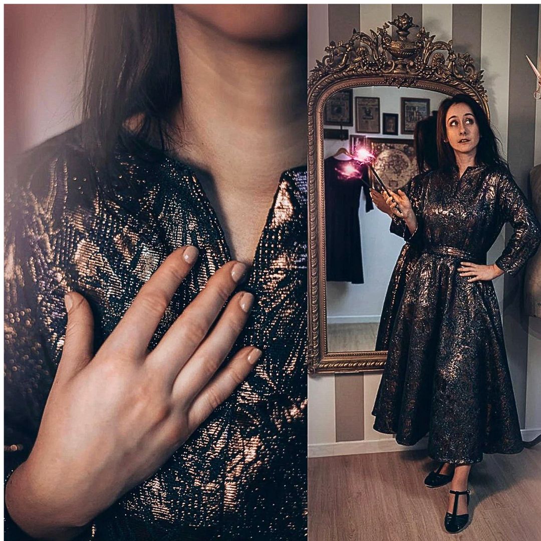 Woman wearing a black sequin dress in front of a mirror.
