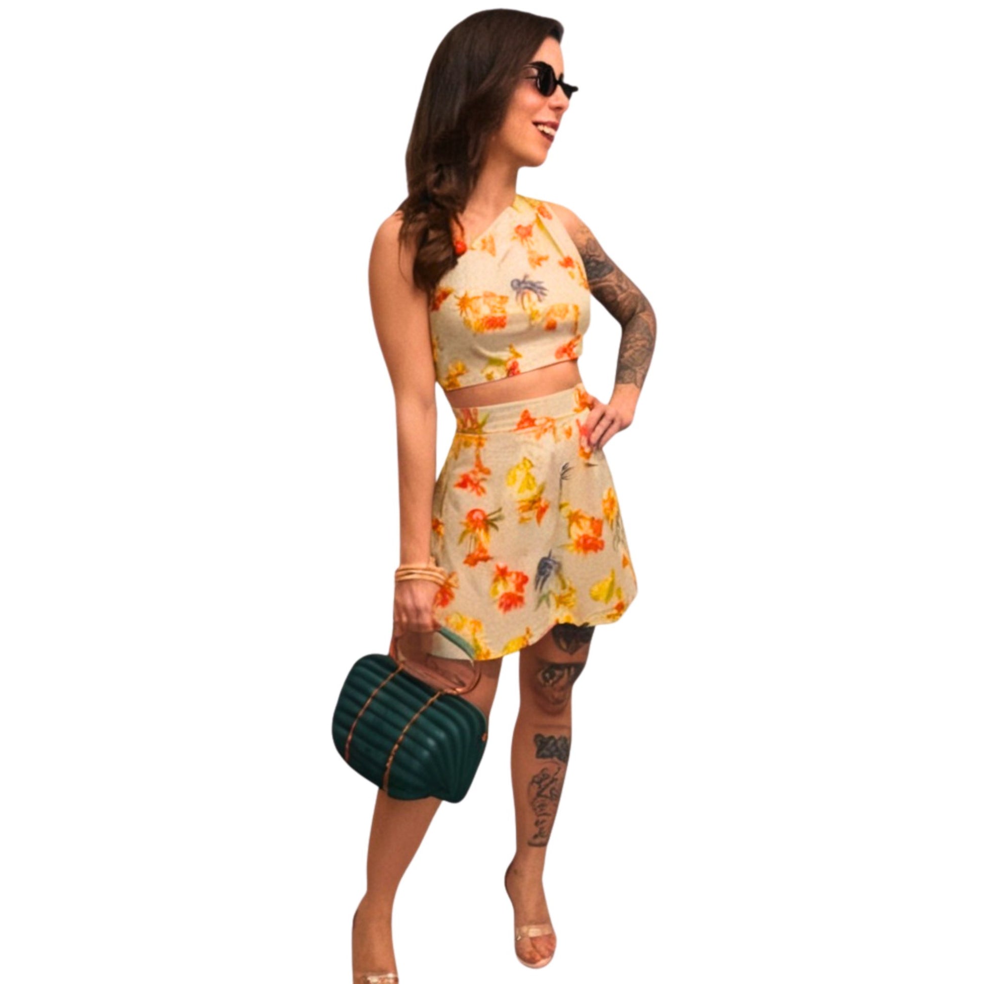 Woman wearing a floral dress and sunglasses on a white background