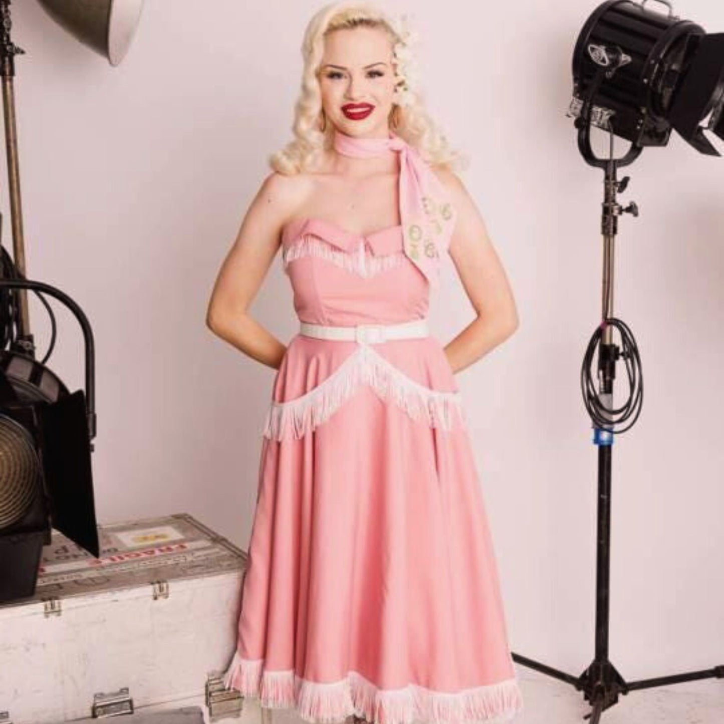 Blonde haired Woman wearing a Pink Rockabilly dress and boleromade up from pattern number  LW13182 available as a multi-sized pattern.