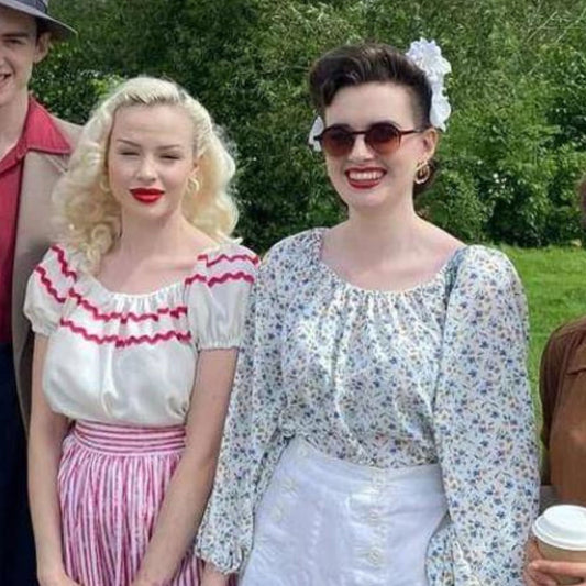 Blonde haired girl and a dark haired girl wearing a 1950s gypsy top