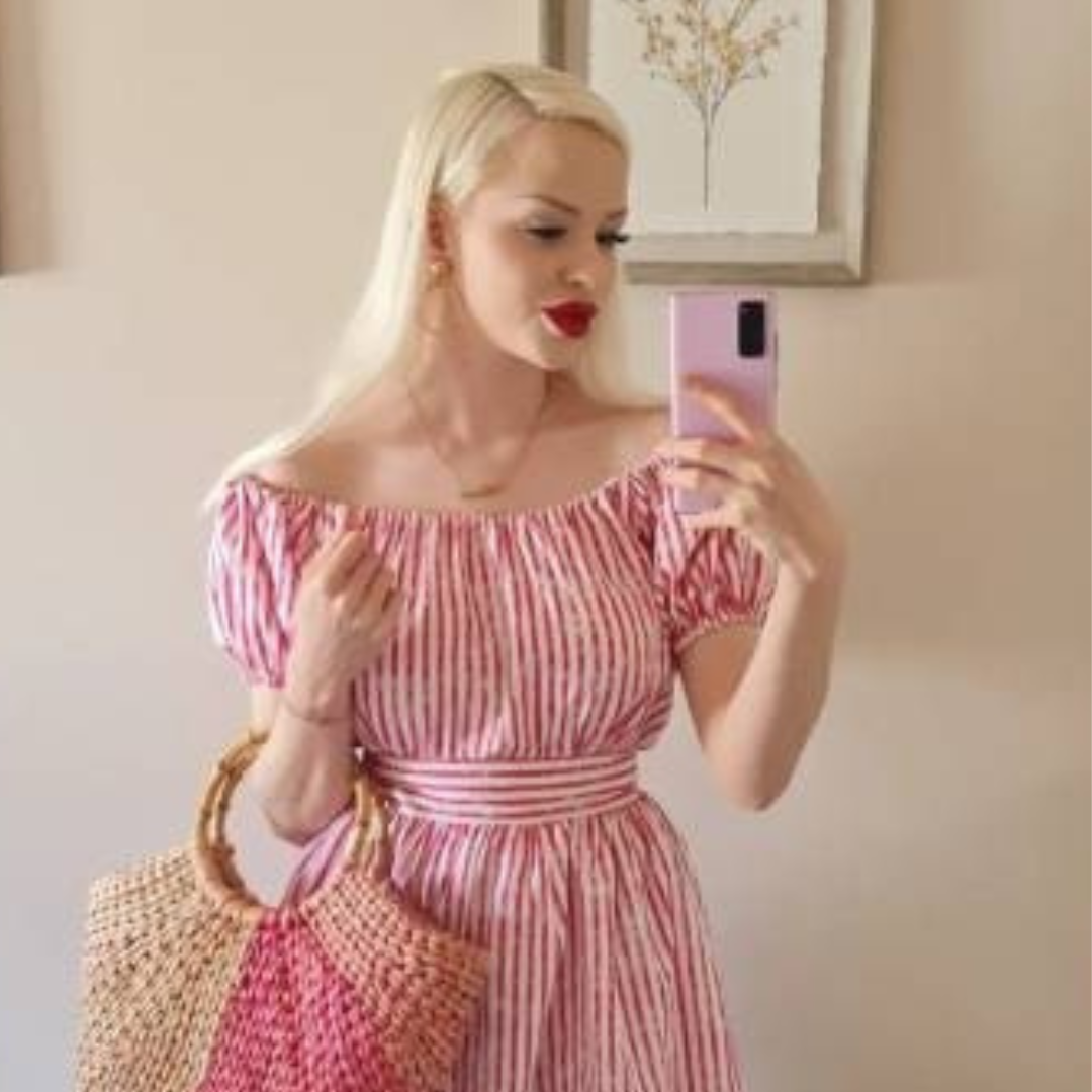 Blonde haired woman weing a red striped gypsey top