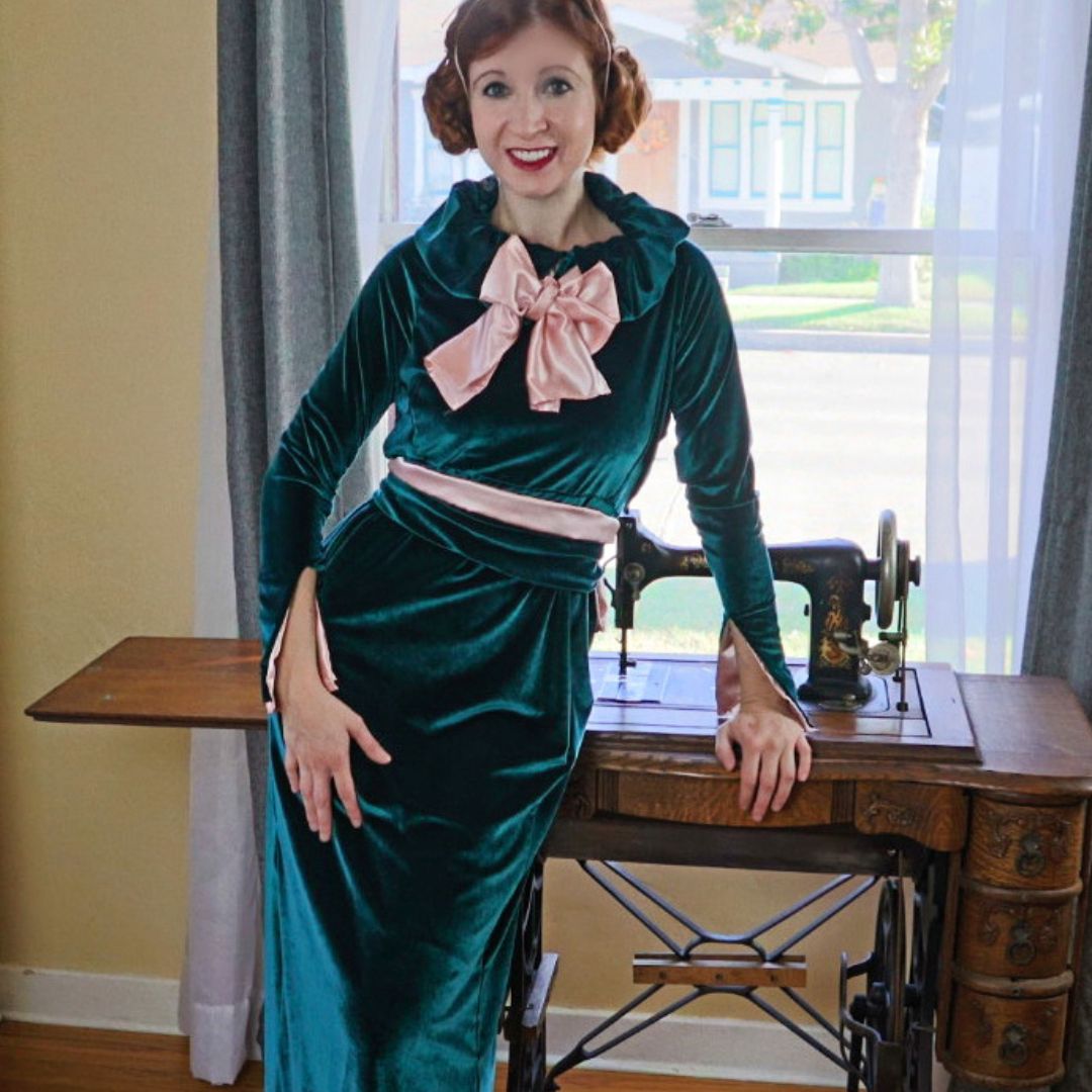Woman wearing a 1930s green and pink dress from pattern 653 