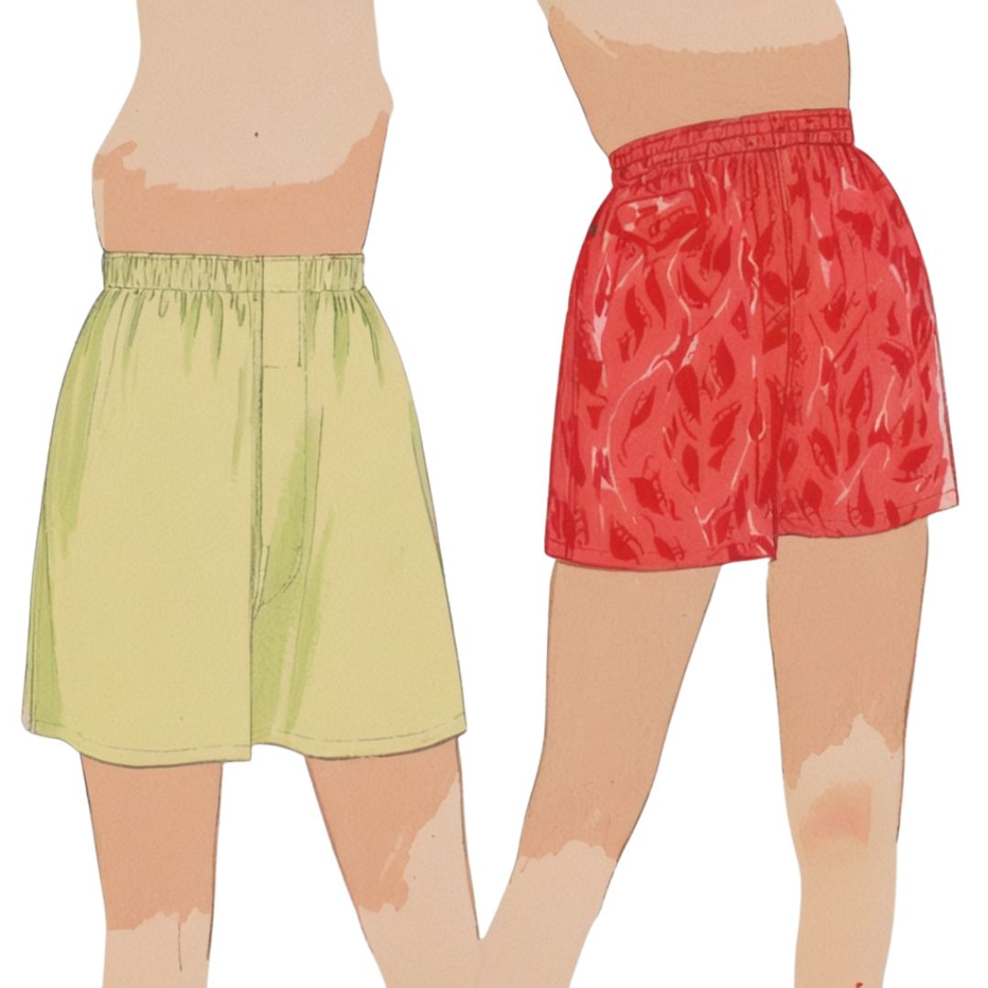 Two pairs of shorts, one green and one red with a flame pattern, on a white background.
