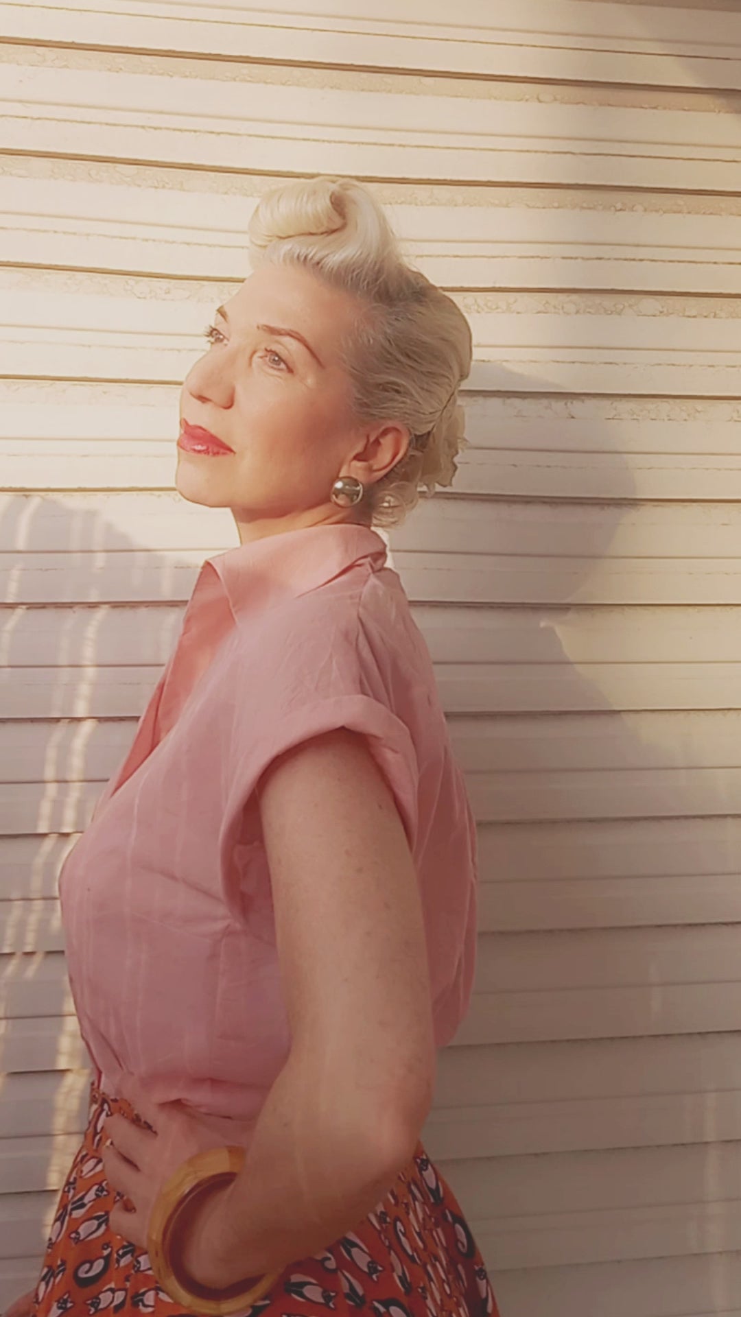 Blonde haired women wearing a pink Arietta Blouse