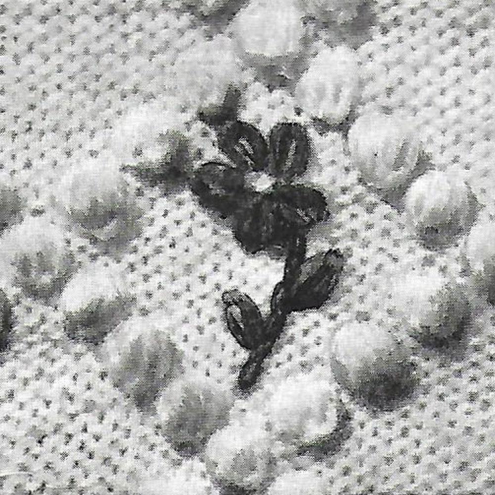 Flower embroidered on jumper.