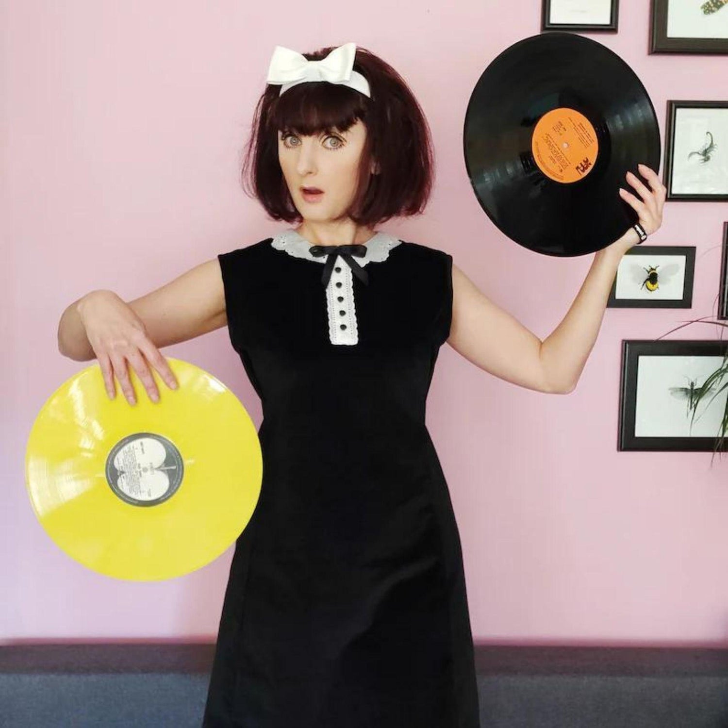 Woman wearing a 1960's Pattern, Mary Quant Style A-Line Mod Dress with vinyl records in her hands