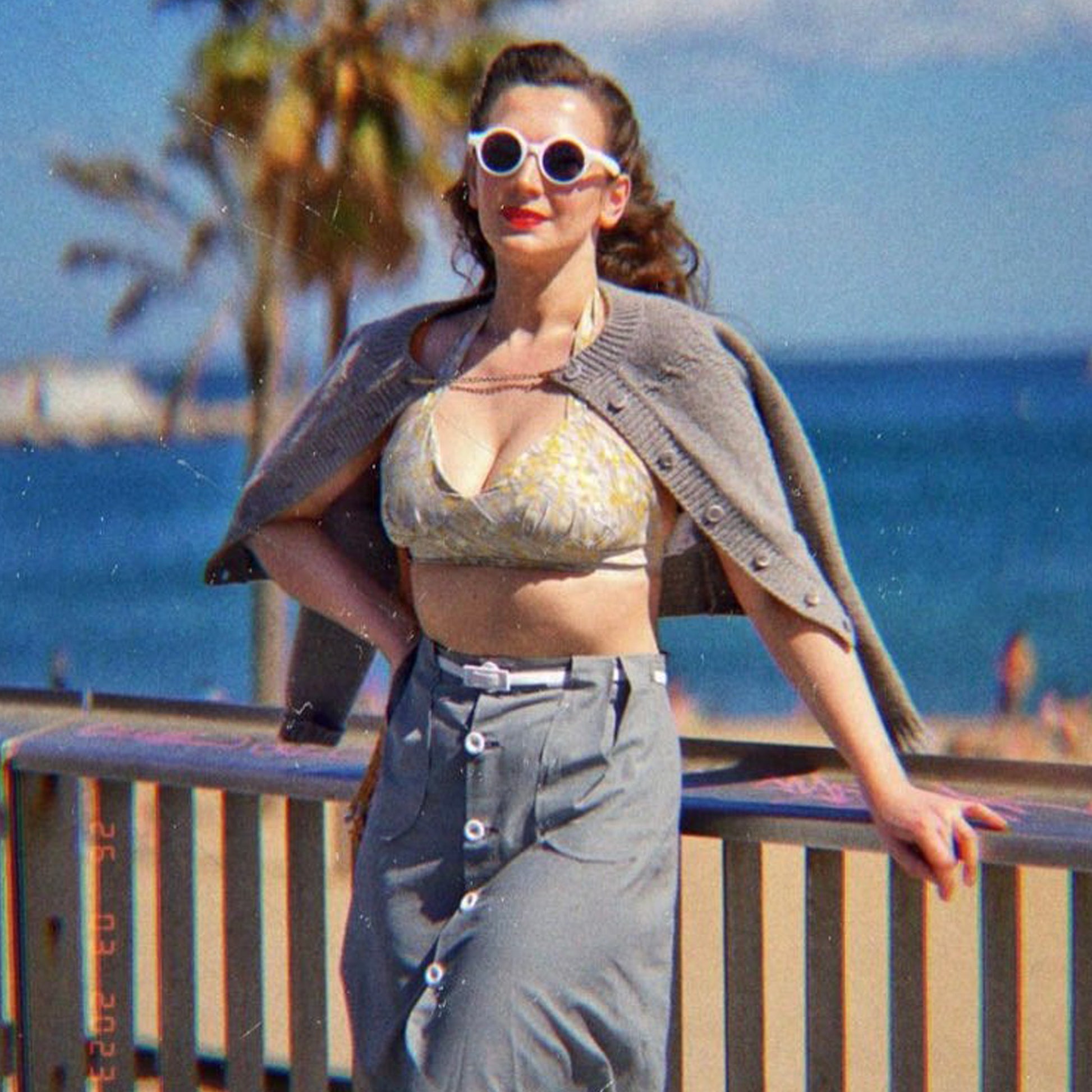 Model wearing 1940s skirt with beach top and cardigan